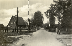 161932 Gezicht op de spoorwegovergang nabij het N.S.-station Putten te Putten, met links een dienstwoning van de N.S.